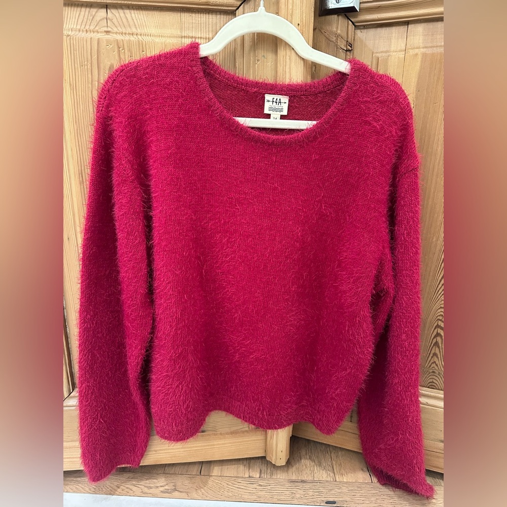 Girls size 14 Pink sweater. Like new condition.